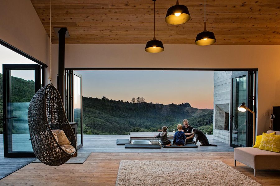 Living room opening onto a deck, Pūhoi